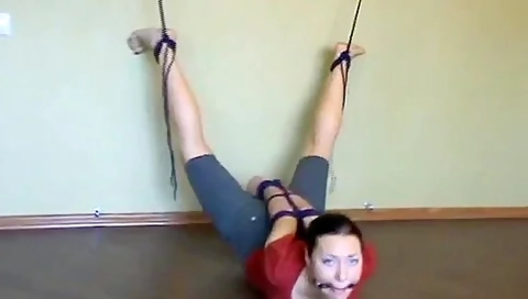 A Barefeet Girl Is Tied To The Wall