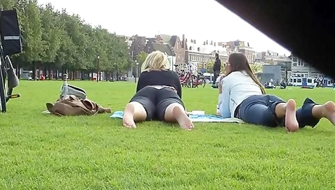 Two Hot Young Unsuspecting Ladies Get Their Cute Bare Feet Filmed On The Grass
