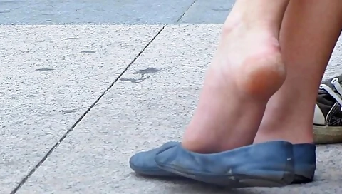Dangling Blue Flats Over Sidewalk