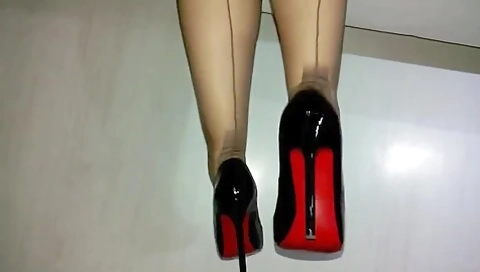 Putting On Stockings And Expensive Louboutin Shoes
