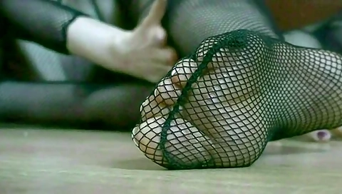 Attractive Brunette Posing In Exotic Fishnet Outfit And Sexy Black Leather Boots