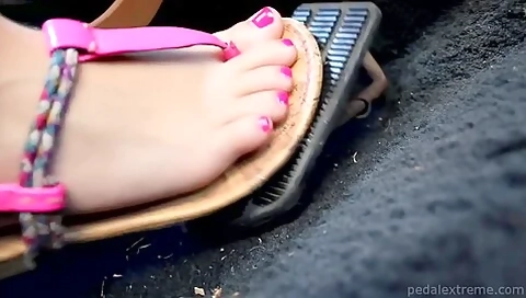 Sexy Foot With Pink Toenails And Sandals Pushes A Gas Pedal Down Rough