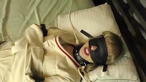 Blindfolded With Straight Jacket On Bed