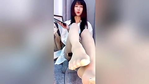 Lonely Korean Babe Displaying Her Sexy Stockinged Feet And Toes In A S