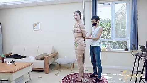 Tied to a pole with dildo gag
